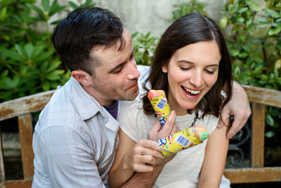An engaged couple share their ice cream during their engagement session in fishtown.